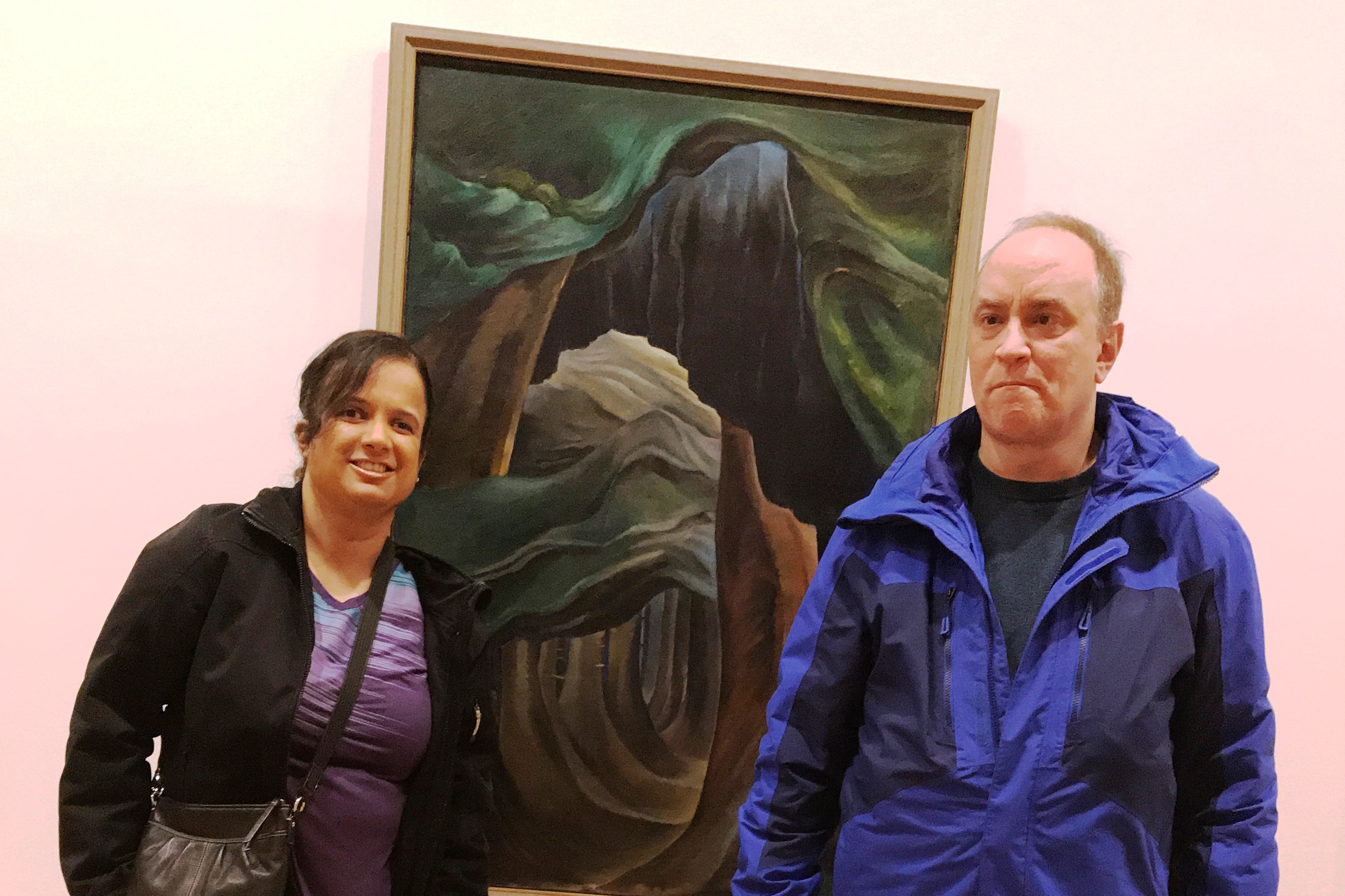 Kristy and Shawn with an Emily Carr landscape between them 